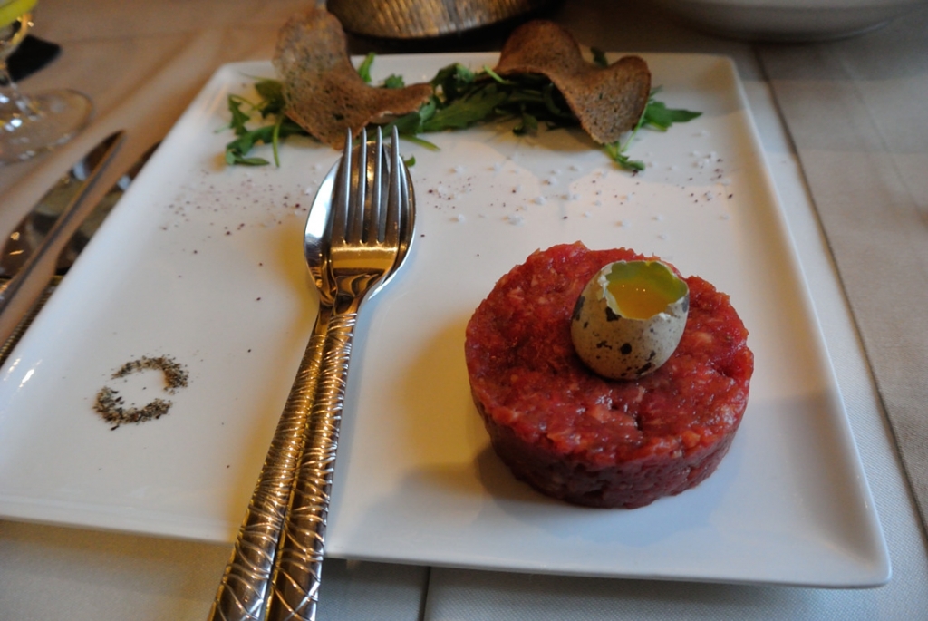 Beef tartare with quail egg and rye bread toast