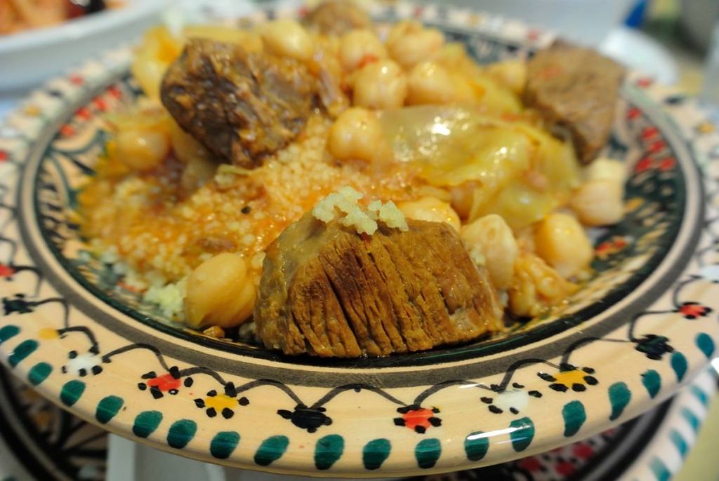 Couscous dish served on traditional Sicilian ceramic plate